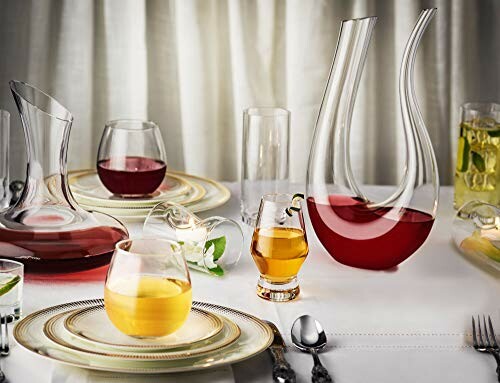 Elegant dinner table setting with decorative glassware and beverages.