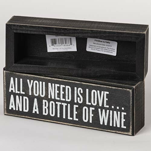 Wooden sign with text 'All you need is love... and a bottle of wine.'