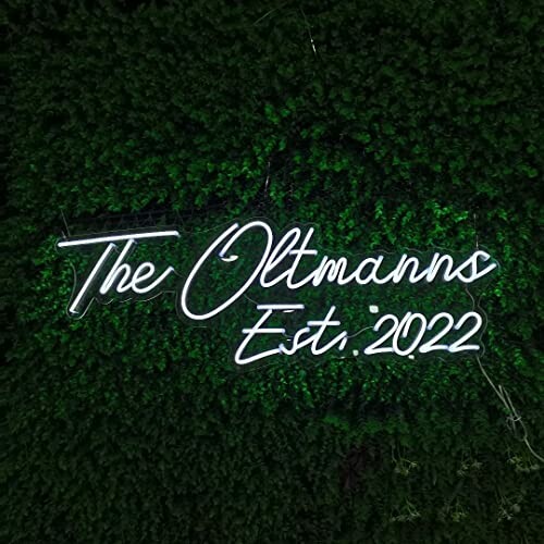 Neon sign reading 'The Oltmanns Est. 2022' on a green background