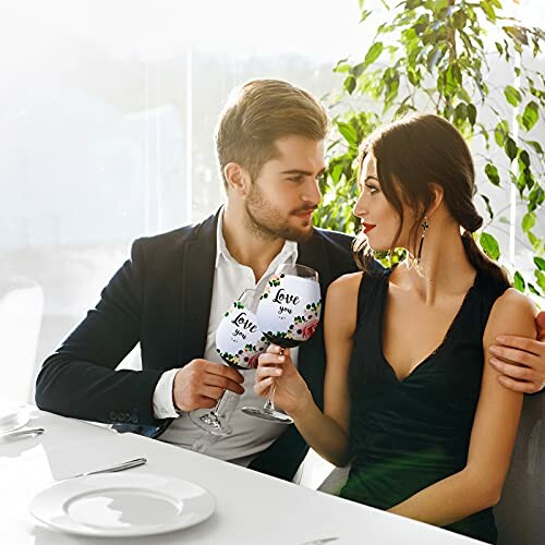 Romantic couple toasting with wine glasses.