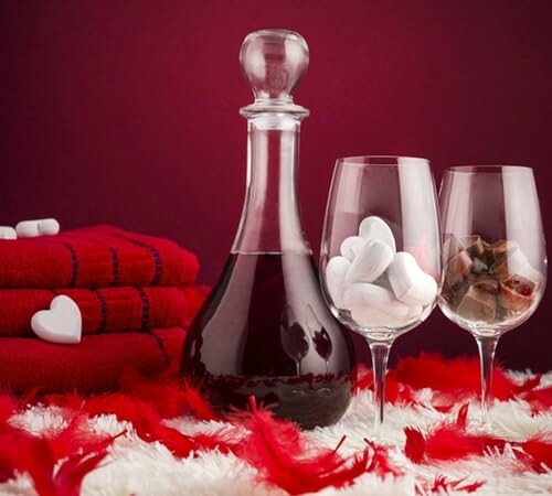 Wine decanter and glasses with towels and feathers