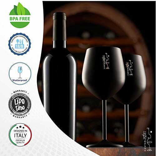 Wine bottle with two black wine glasses and quality badges