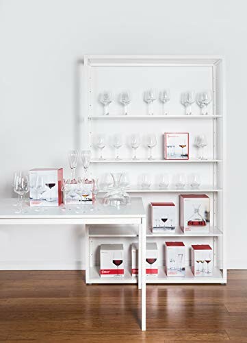 Display shelf with various wine glasses and boxes on wooden floor.