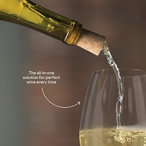 White wine pouring from bottle into glass with cork in neck.