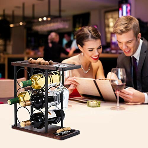 Wine rack with bottles and glasses, couple dining in background.