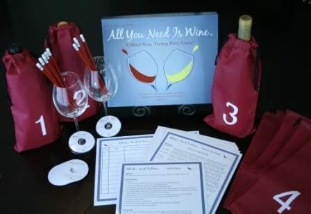 Wine tasting kit with glasses, covered bottles, and instructions.