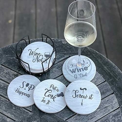 Wine glass on table with humorous wine-themed coasters.