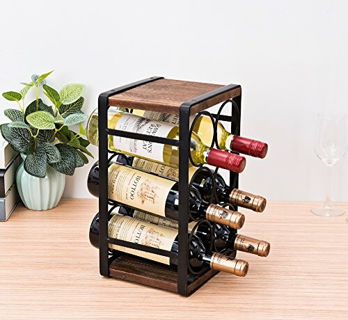 Wooden wine rack holding multiple bottles on a table.